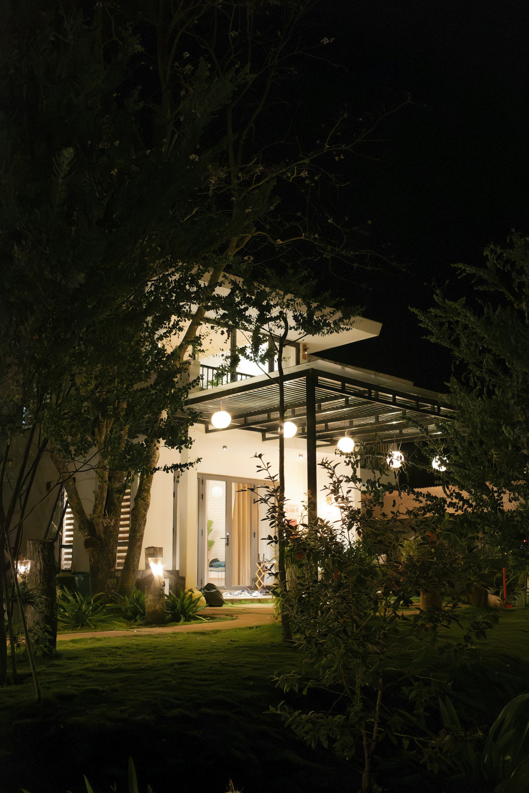 Modern home illuminated with landscape and exterior lighting